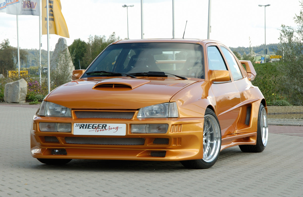 Opel Kadett E Rieger Spoilerstoßstange Breitbau II  mit Aussparung für NSW, GFK, 
Montagezubehör
