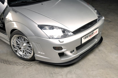Ford Focus 1 Rieger Spoilerstoßstange -> bis Modell 10/2001 mit Aussparung für Blinkleuchten, mit seitlichen Rippen, ABS, für Fzg. mit Scheinwerferreinigungsanlage, 
inkl. Alugitter, Montagezubehör, ABE
